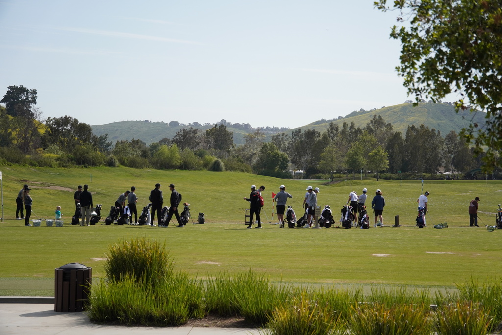 Both teams warming up before the round.  Exciting to use the grass on the range finally after all the rain.