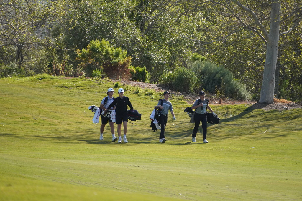 Heading off to hit a second shot on hole 1.