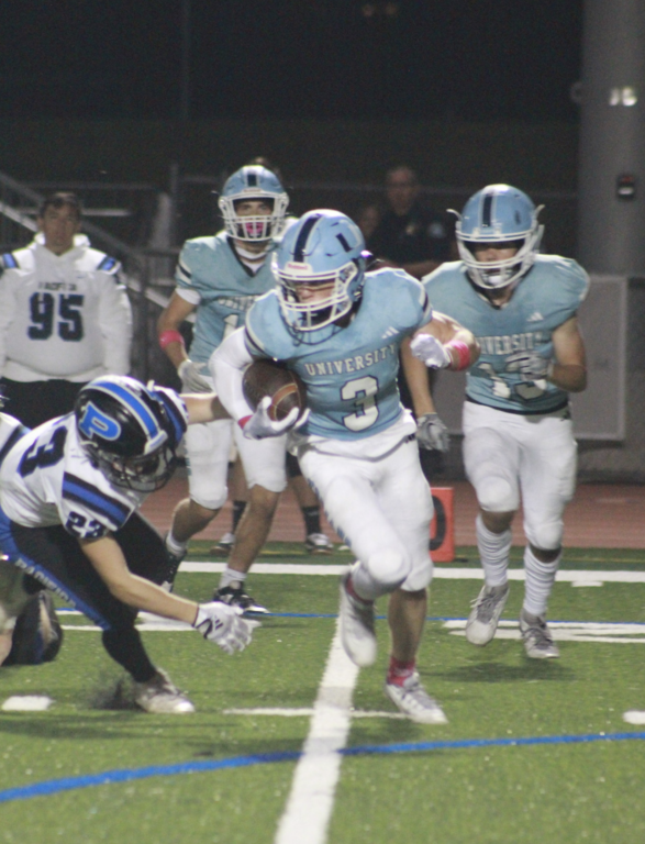 #3 Senior Captain Kick Returner Carl Oldham eludes Mariners defender and turns upfield for the Trojans