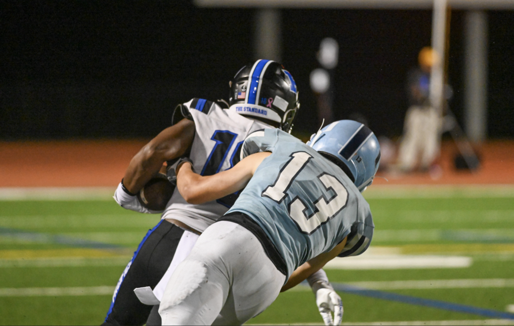 #13 Linebacker Pierce Fournier makes the tackle on Pacifica's wide receiver.