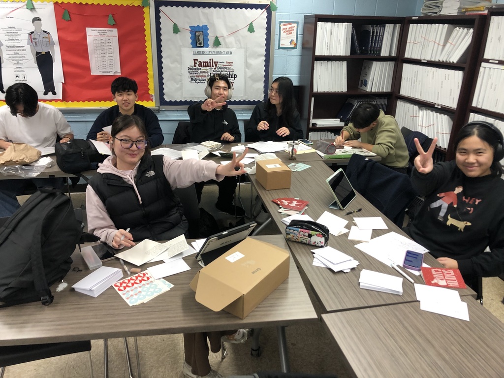 Leaders working late to write holiday cards to their cadets.