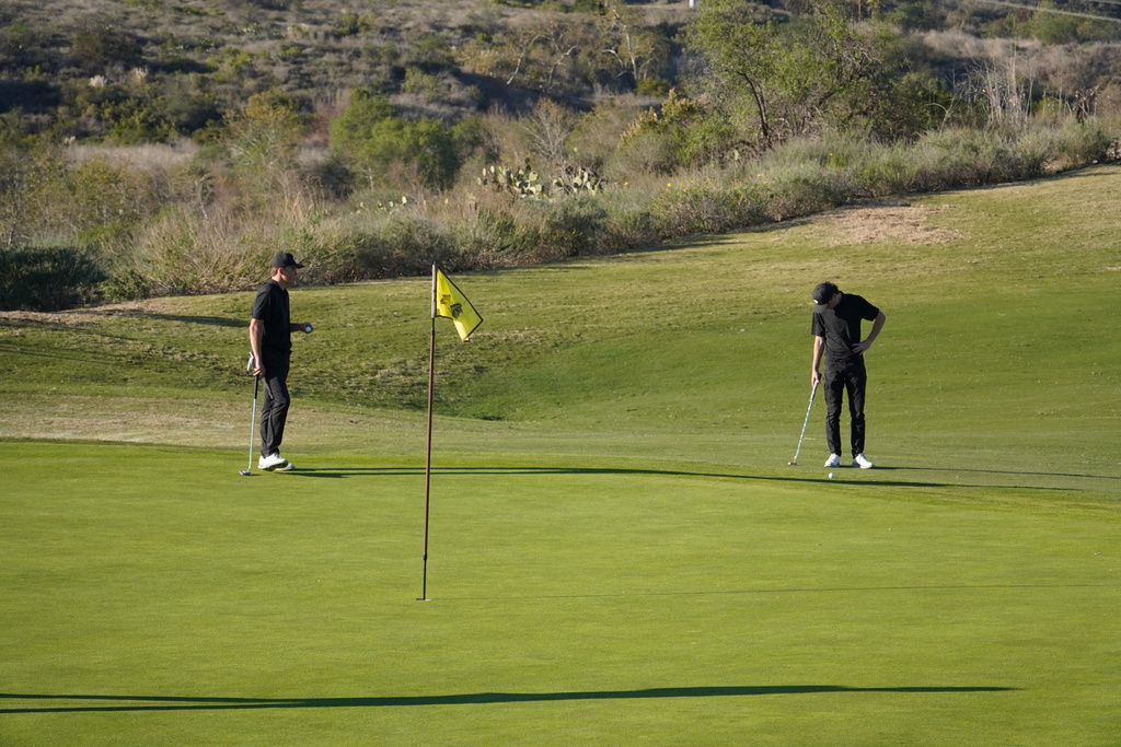 Finn and Adam on the green of hole 7.  A 540 yard par 5.  Finn is putting for Eagle and Adam is putting for birdie.  They both ended up with a birdie.  Nice job!
