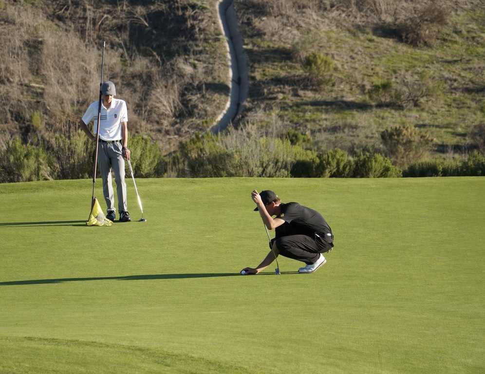 Hollan lining up for his final putt of his round on hole 9.