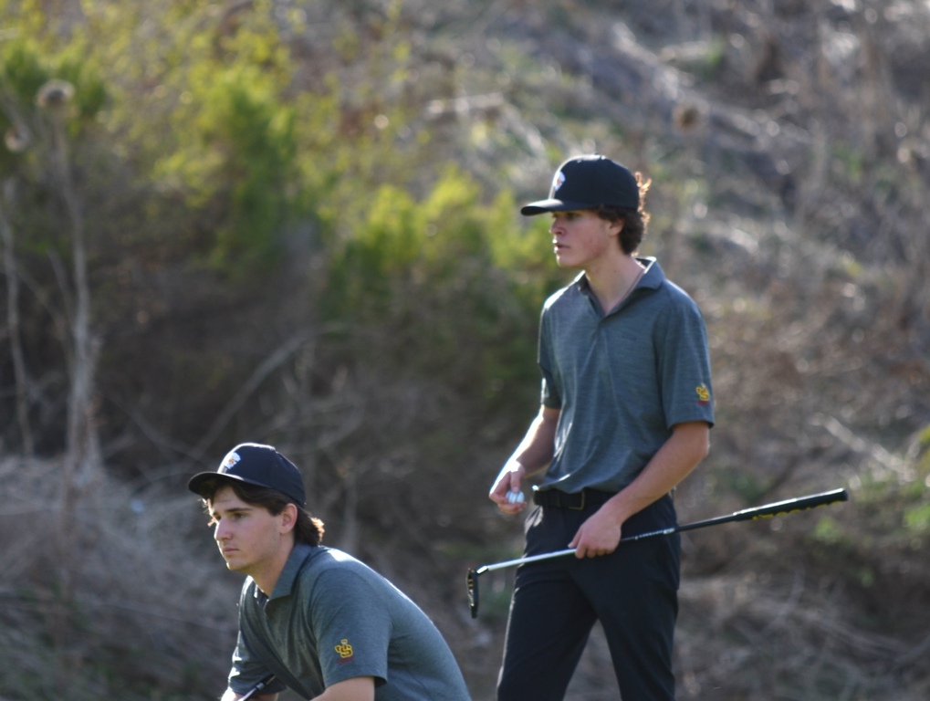 Jacob and Ryan are studying the green for their next shot.