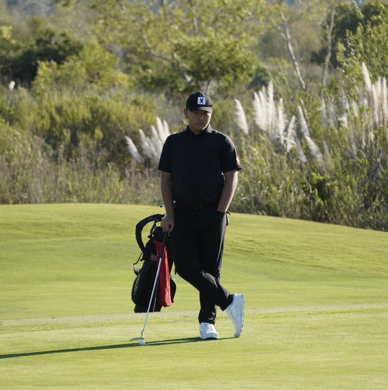 Lucas waiting for his turn to putt.