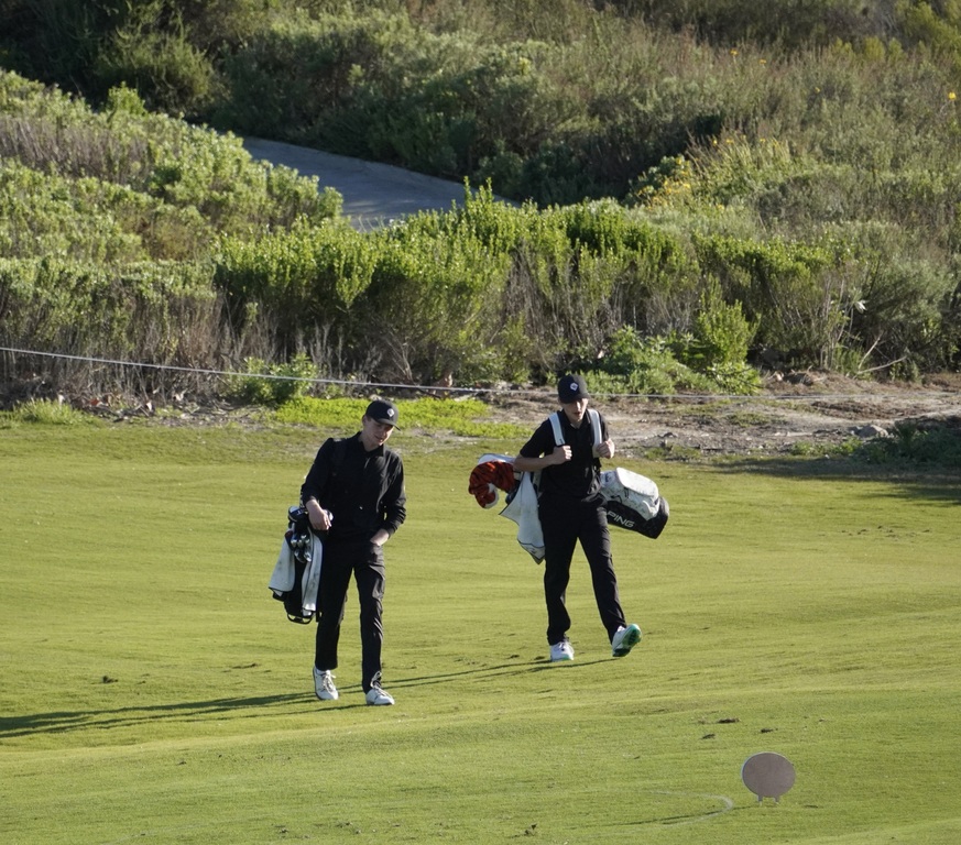 Gavin and Jase walking to the green of hole 4 a downhill par 3.