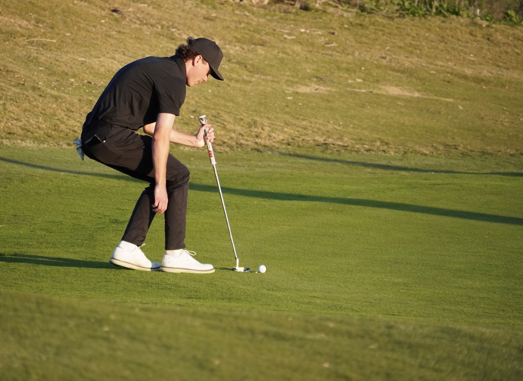 Adam lining up his final putt for the round.