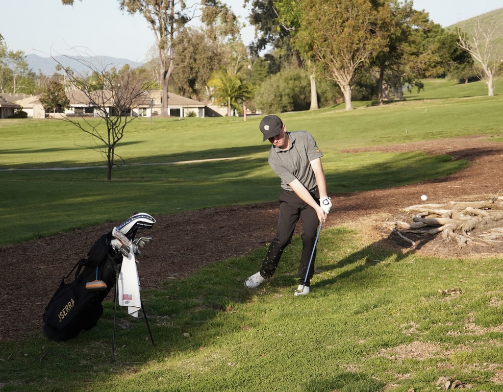 Liam chipping onto the green of hole 8.