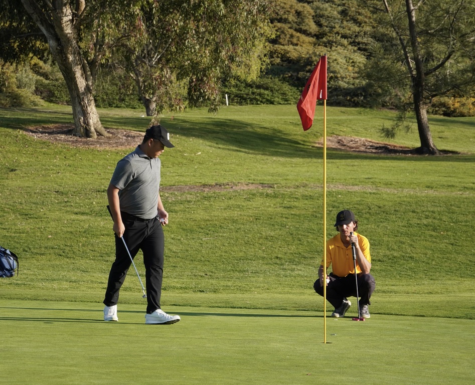 Lucas putting on the green of 8 and finishing up the hole with a birdie.