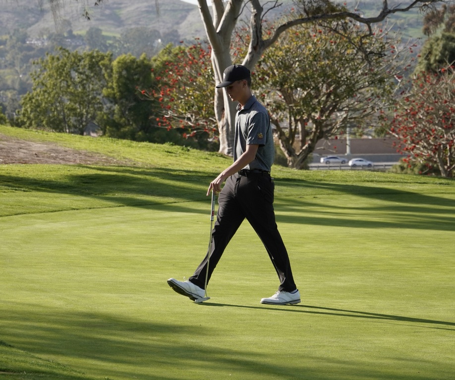 Hollan walking off the green of hole 6.