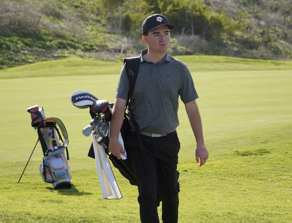 Liam walking to the next tee box.