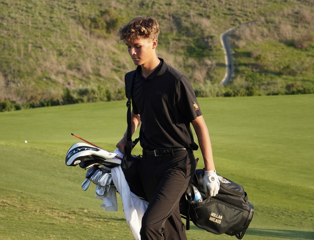 Hollan walking to the green of hole 9 to finish his round.