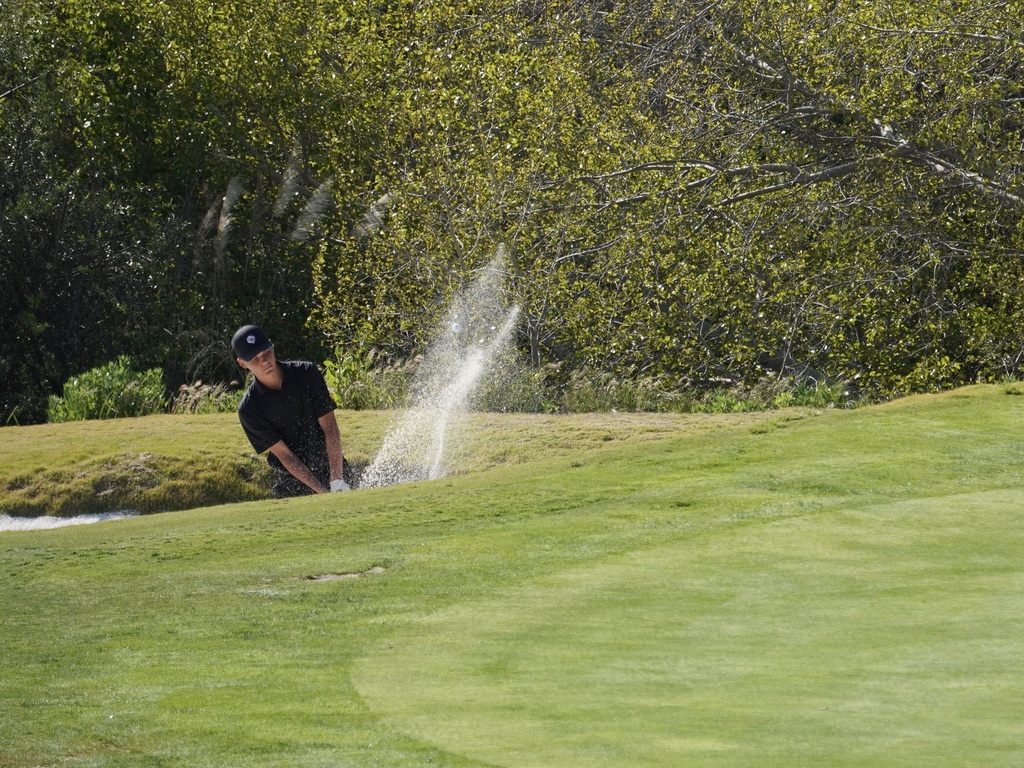 Hollan getting out of the bunker on hole 3.