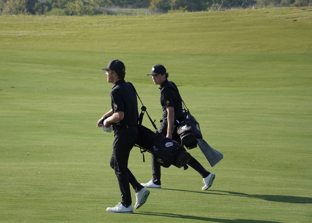 Finn and Adam walking down the fairway of hole 7.