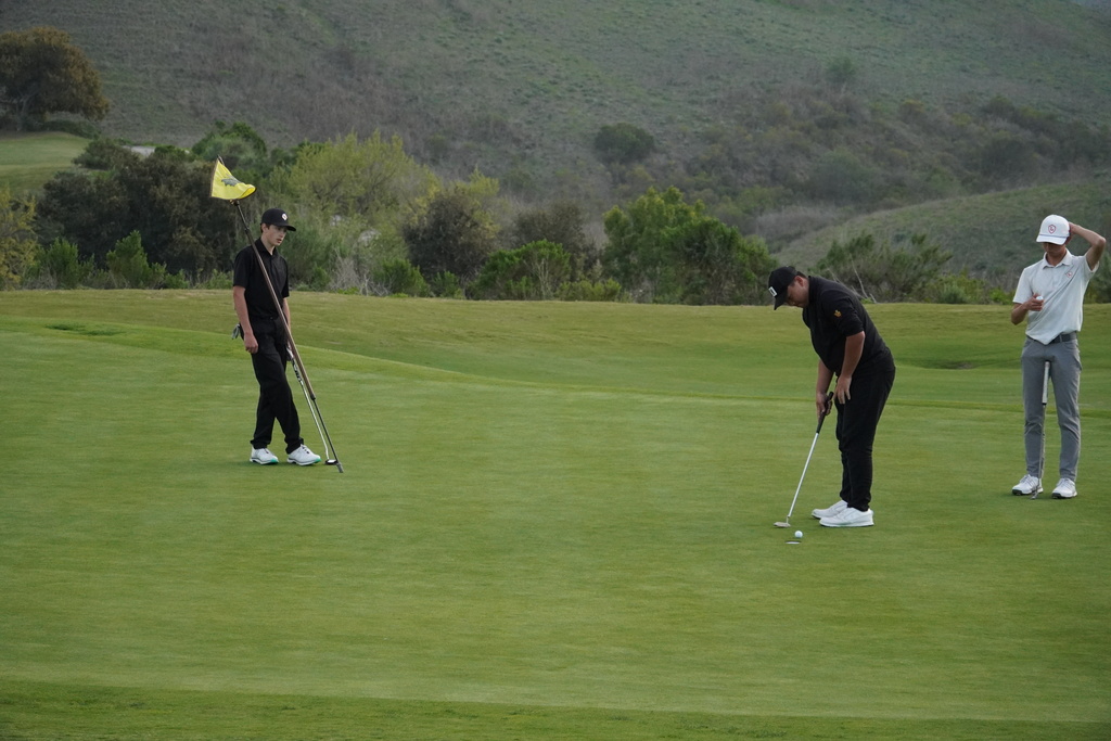 Jase and Lucas finishing the round on the green on hole 9.