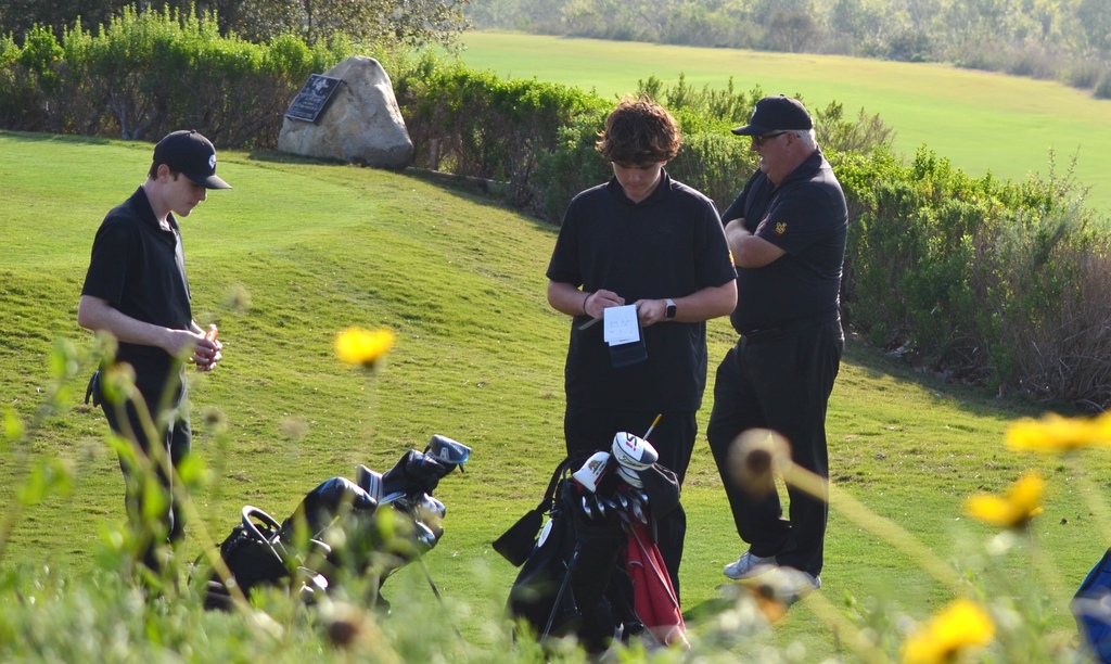 Coach Tom is discussing how to play this next hole of golf.
