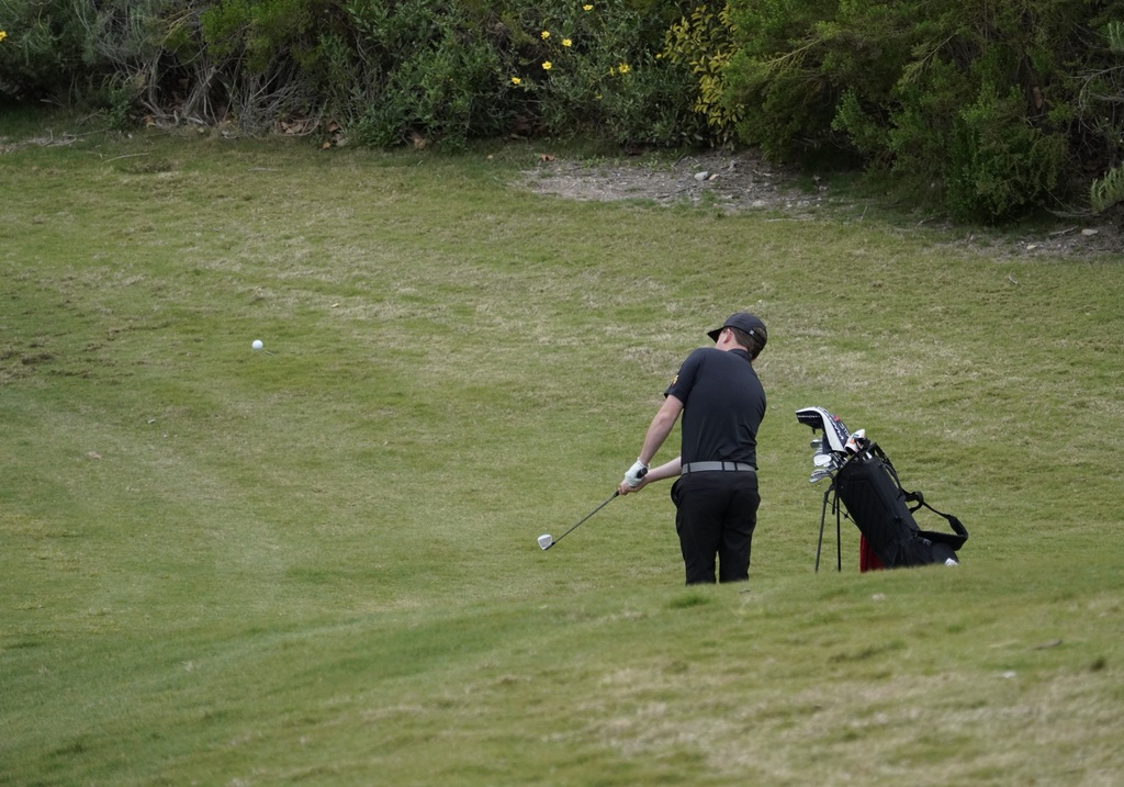 Liam chipping on to the green of hole 2.