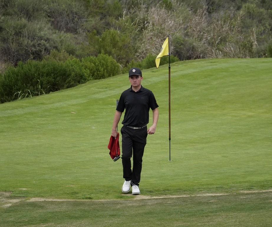 Liam walking off the green on hole 6 with a birdie.