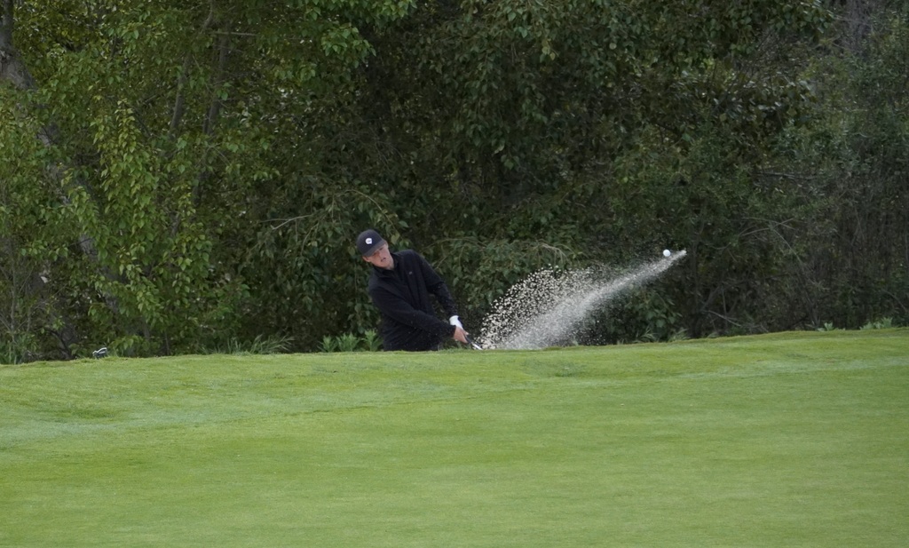 Finn hitting out of the bunker next to the green of hole 3.  Finn was able to make birdie after his bunker shot and putt.