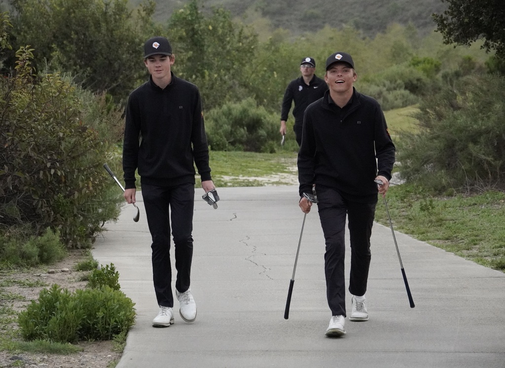 Finn and Gianni leaving the green of hole 8 with with a pair of pars.