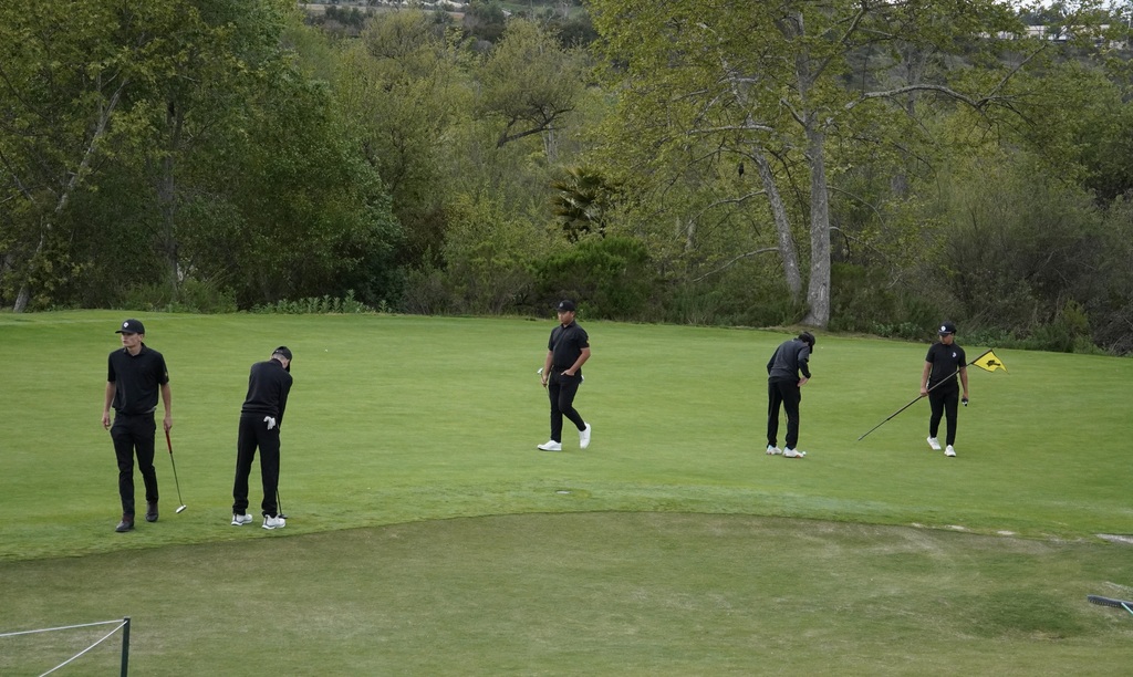 Lucas, Jase and Hunter on the green of hole 3.