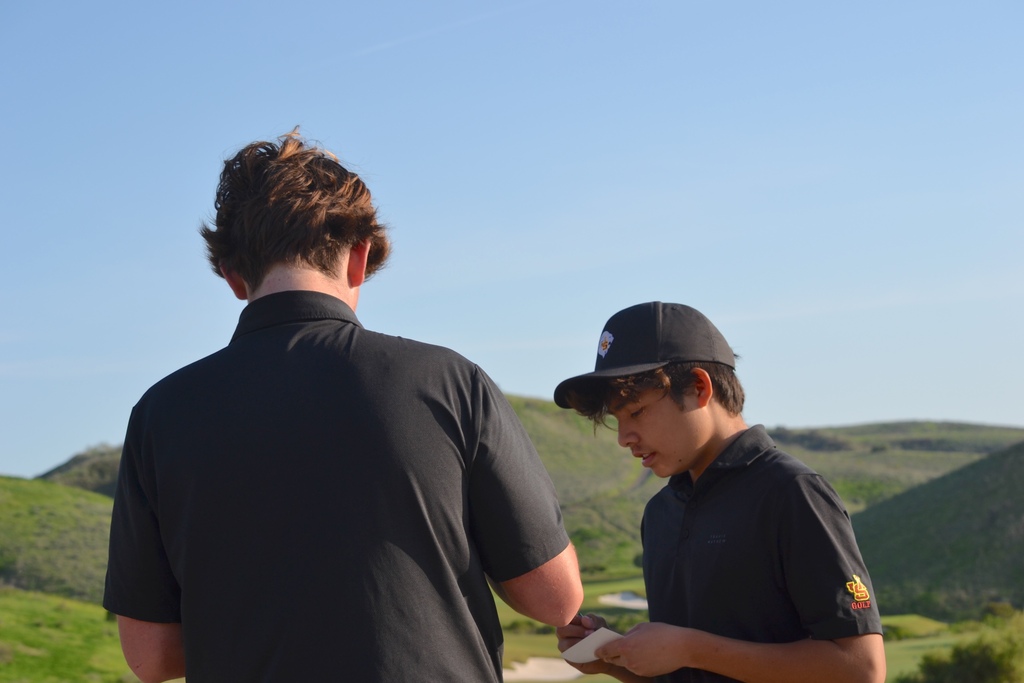 Louie and Kaikoa are adding up their scores. Even though JV came up short, they played a great round of golf.