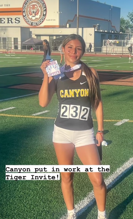 Alessandra earning a medal in the 300 hurdles!!