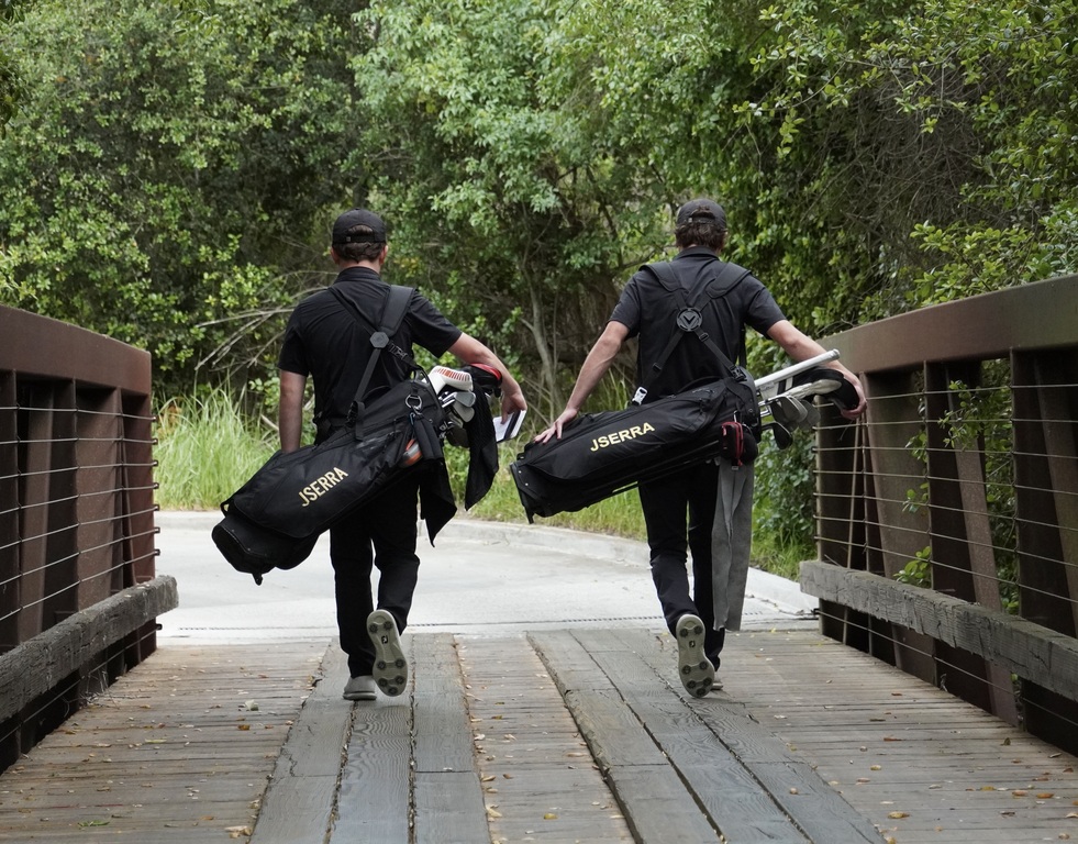 Liam McNamara and Adam Rusin crossing the bridge from the green of hole 1 to the tee box of hole 2 for the last time as a JSerra golfer.