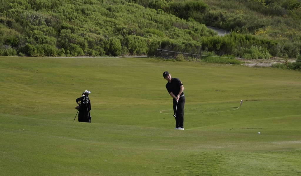 Liam McNamara with his second shot on hole 4 a par 3. Liam finished the hole with a par.