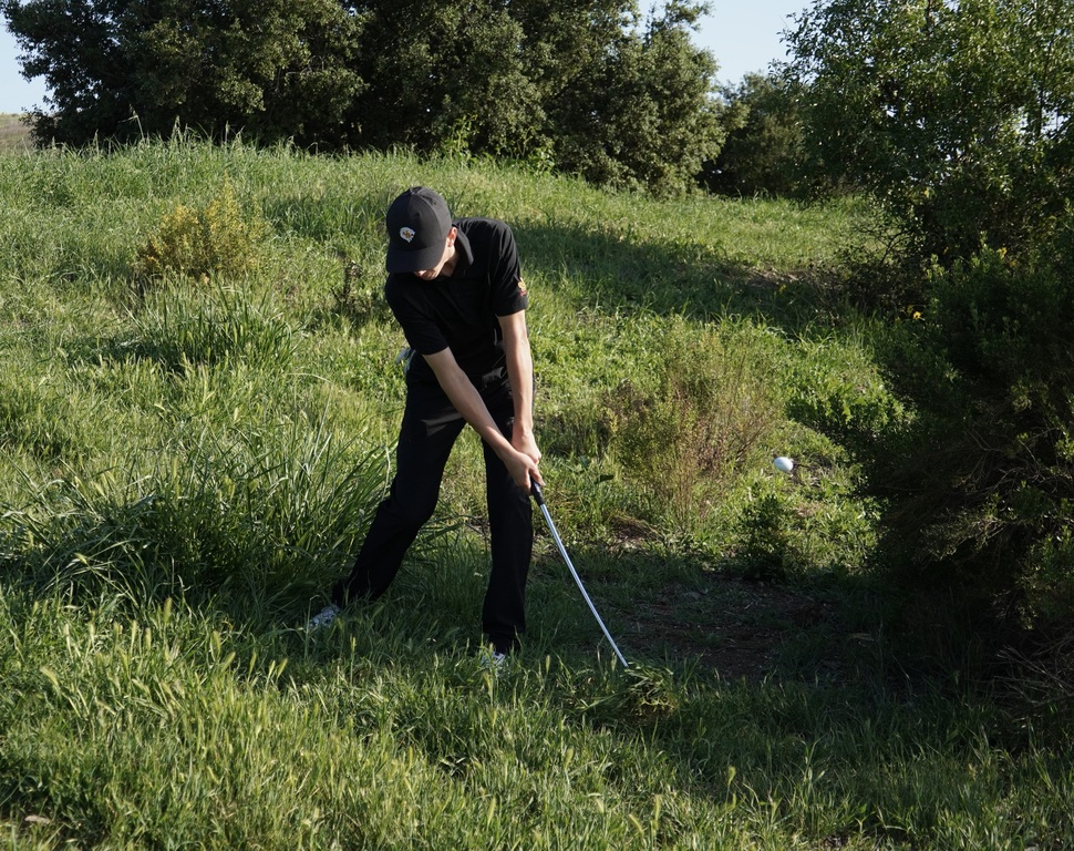 Jase chipping out of the hazard on hole 7 after a very long approach shot.