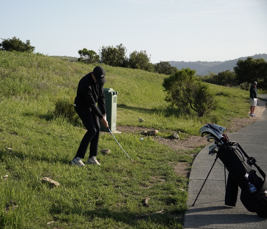 Grayson chipping onto the green of hole 7.