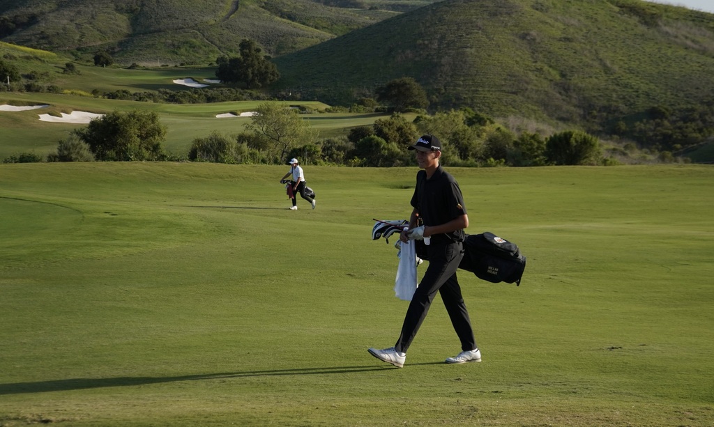 Hollan with a big smile as he walks to the green of hole 9.