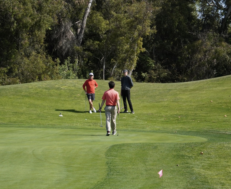 Liam, Anthony and Charlie planning their strategic chip onto the green in the Senior Match Scramble.