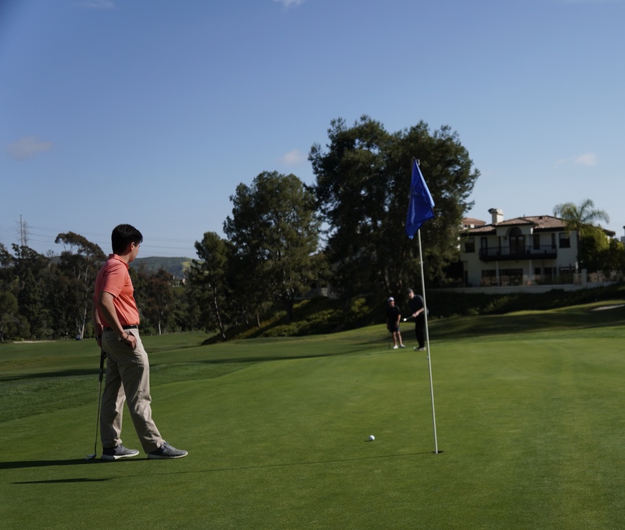 Charlie doing his best to make the putt while Anthony guards his two foot birdie putt for the team.  Graduation gift ideas for Anthony...a ball marker with his college logo??