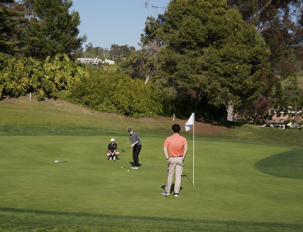Hole 8. A collaborative moment with Varsity Liam and Charlie and Anthony JV2 putting for eagle.  They were able to make birdie to go into hole 9 with 6 under par.