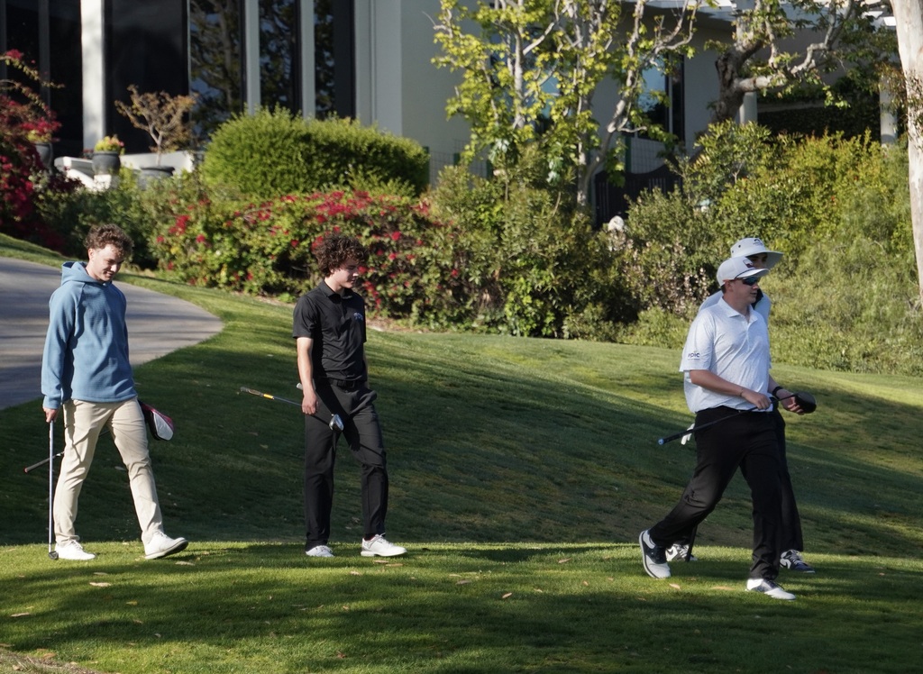 Lots of relaxed smiles for the boys as they head down the downhill hole of 9.  Scramble golf is definitely more easy on the mental health.