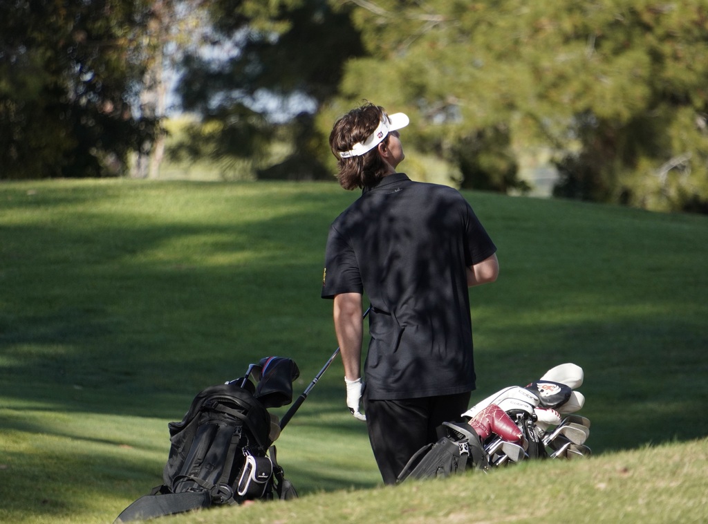 Watching the tee shots of his scramble teammates finish up on hole 9.