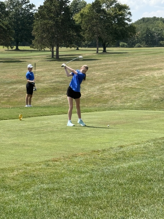 Piper practicing her swing