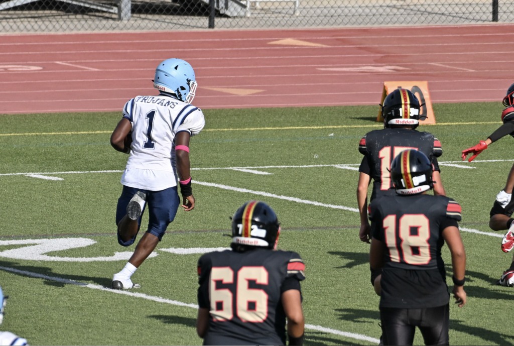 JVs running back Deandre Miller with a full head of steam down the sideline