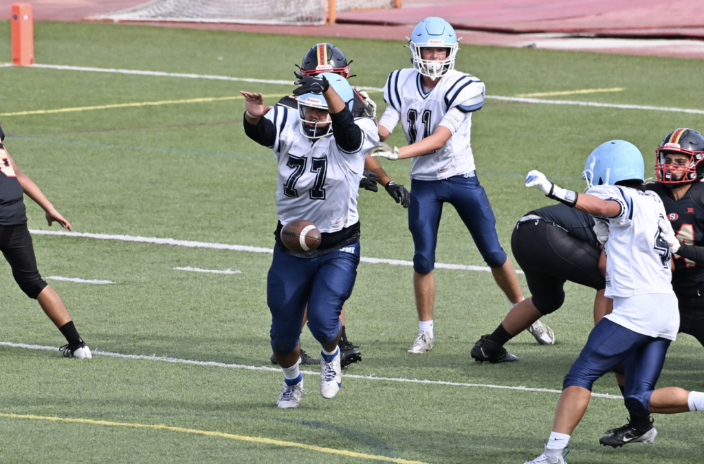 Cristian Cabezas gets in to block the kick for the JV Trojans