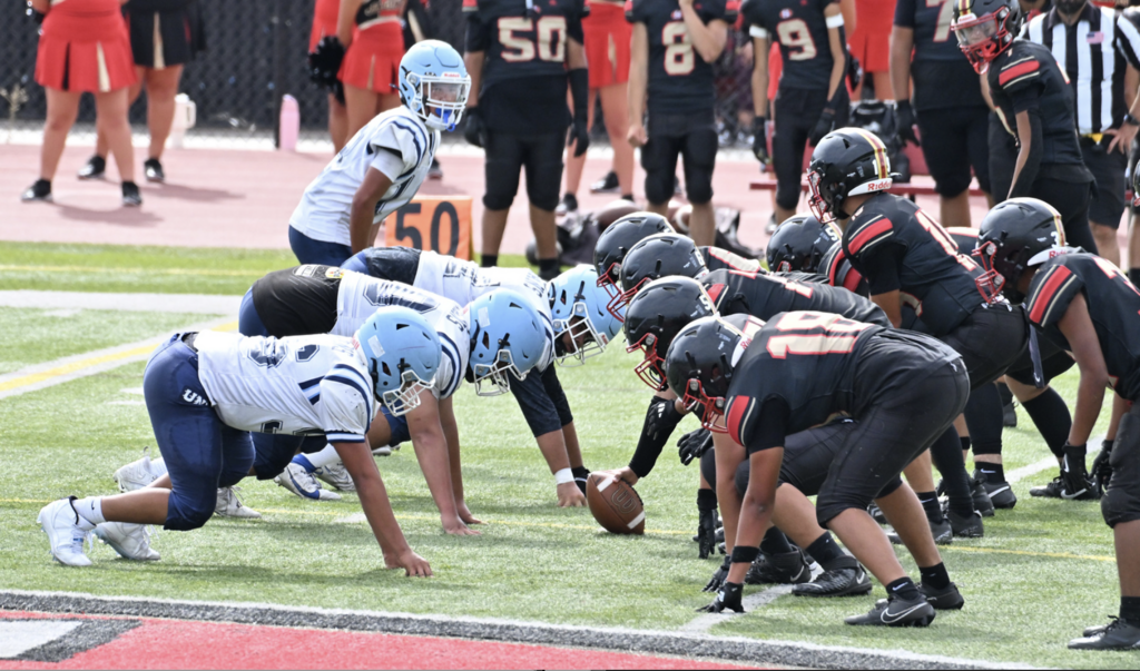 D Line for JV Trojans set in formation to attack the Jaguars