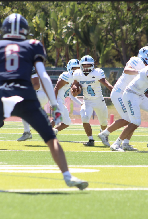 Varsity running back Jacob Najar hits the hole against the Eagles