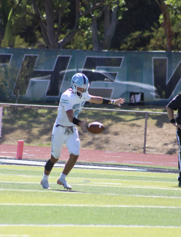 All Purpose player and punter Jake Rabold launches a huge kick of 61 yards for the Trojans
