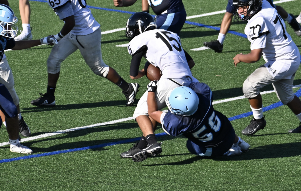 Freshman Linebacker Tyler Youn tackles the Lobos player