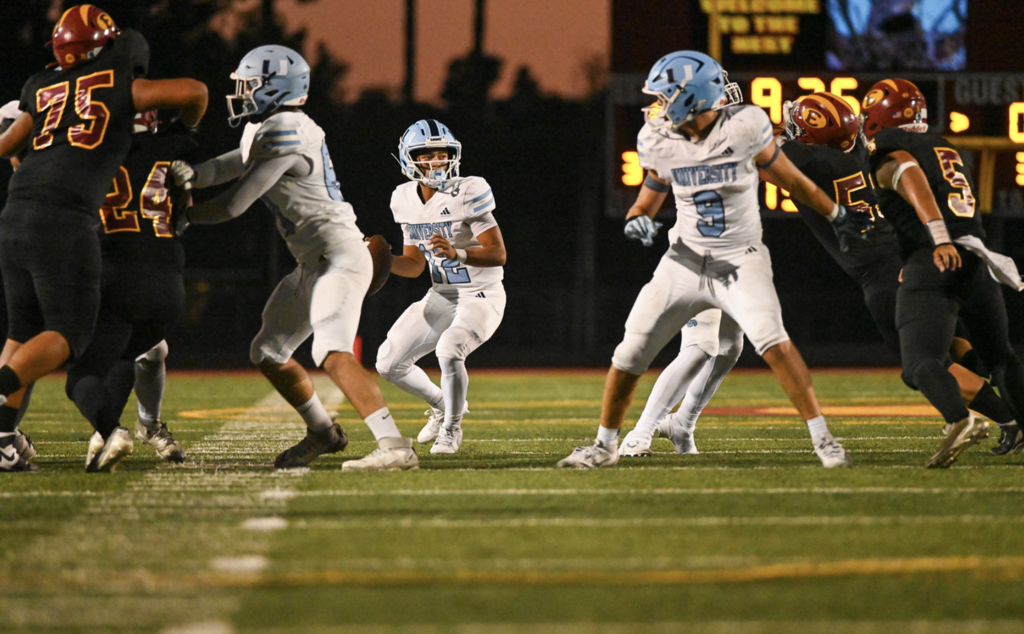 QB #12 Dylan Elmer looks to throw downfield while  in the pocket