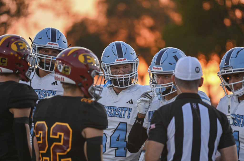 Prior to the game, senior captain #54 Max Encheff meets with fellow captains, the referee and the Estancia Eagles for opening coin toss