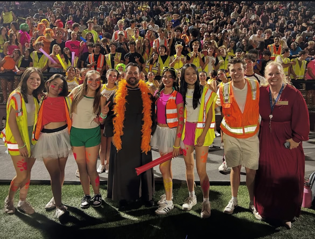 President Jennifer Harris and Fr. Roberto joined @salpointe_stuco on the field at last Friday's Comeback football game! #LancerLife