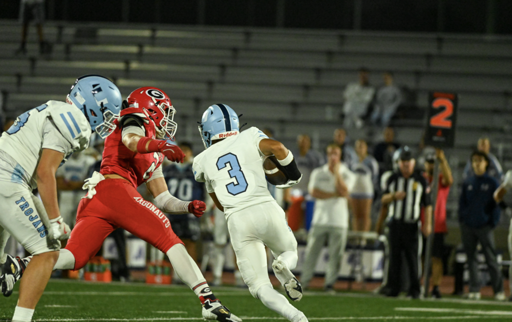 #3 Joey Davis turns the corner upfield for the Trojans