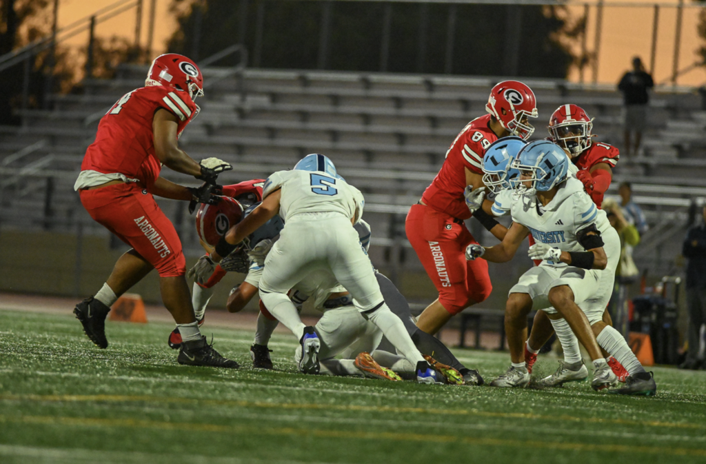 #5 Senior Captain Luke Emrich levels the boom on the Garden Grove ball carrier