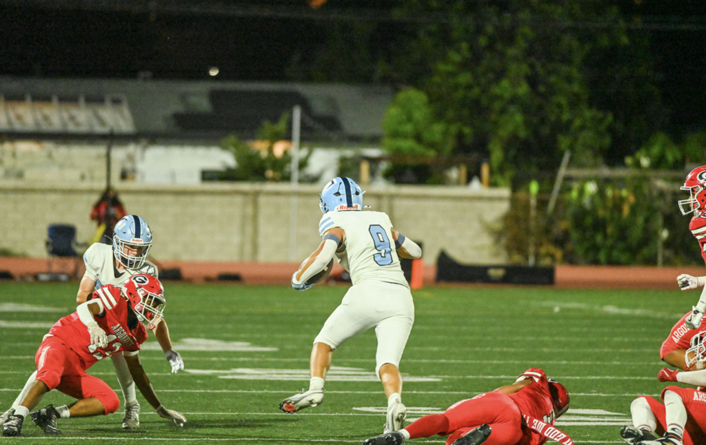 Senior Running Back #9 Lucca Clouthier finds the gap for the Trojans